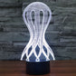 LED desk lamp with glowing white wireframe jellyfish style shade and black base