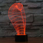 Cobra-style wire grid desk lamp glowing orange-red on a black cylindrical base
