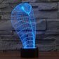 Cobra-style wire grid desk lamp glowing blue on a black cylindrical base
