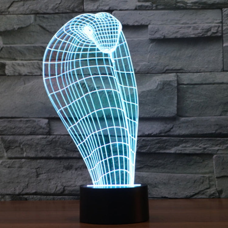 Cobra-style wire grid desk lamp glowing light blue on a black cylindrical base