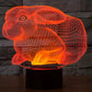 Orange glowing rabbit-shaped night light desk lamp on a black base