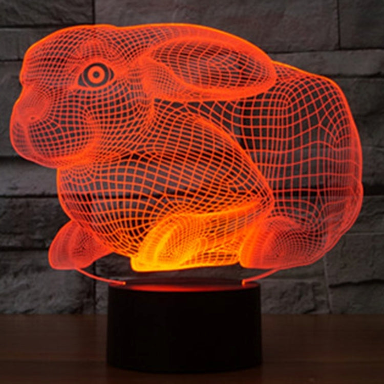 Orange glowing rabbit-shaped night light desk lamp on a black base