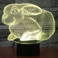 Yellow glowing rabbit-shaped night light desk lamp on a black base
