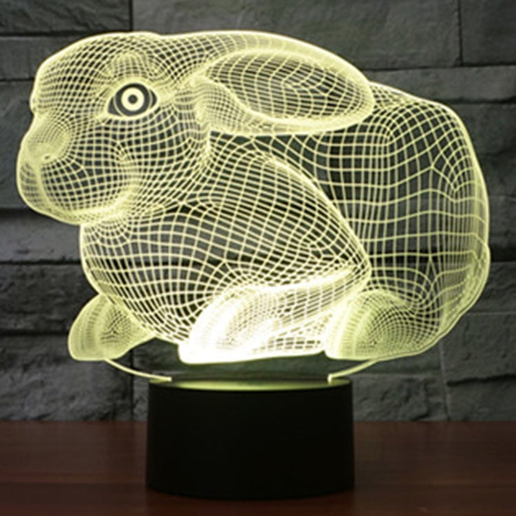 Yellow glowing rabbit-shaped night light desk lamp on a black base