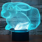 Cyan blue glowing rabbit-shaped night light desk lamp on a black base