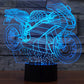 Motorcycle-shaped LED desk lamp, blue glowing wireframe on black base