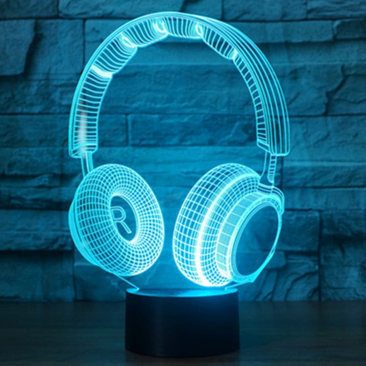 Headset-shaped desk lamp with light-blue LED glow on round black base