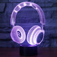 Headset-shaped desk lamp with purple LED glow on round black base