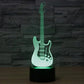 Guitar-shaped LED night light with black base, green glowing guitar