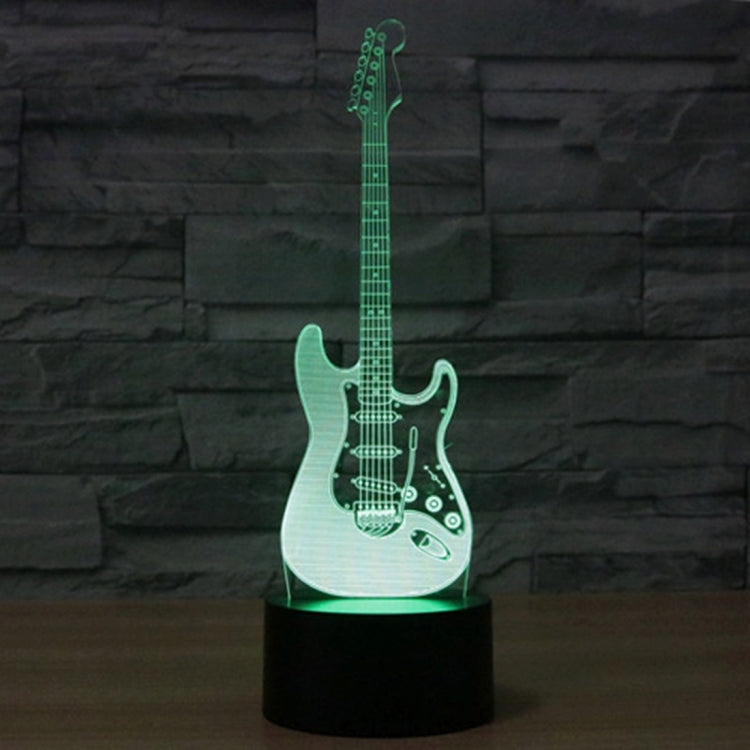 Guitar-shaped LED night light with black base, green glowing guitar