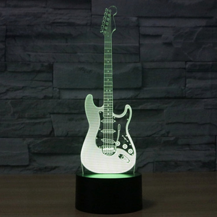 Guitar-shaped LED night light with black base, white guitar with green glow