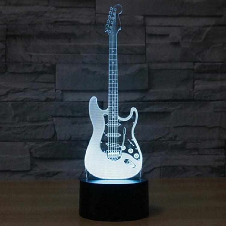 Guitar-shaped LED night light with black base, blue glowing guitar