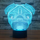 Dog-shaped desk night light with blue glowing lines and black base