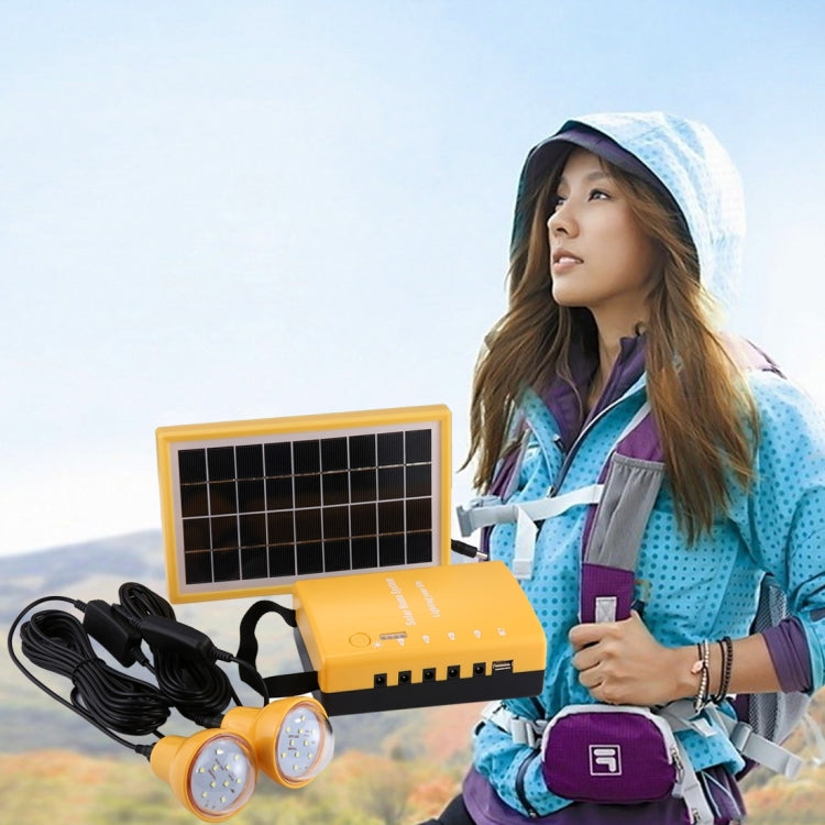 Portable solar light kit with yellow power box, solar panel, and two round bulbs