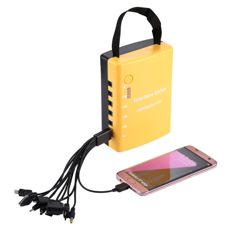 Yellow portable solar power unit with cables and smartphone connected