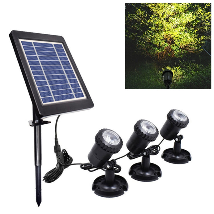 Solar stake spotlight set with blue solar panel and three black ground lights, warm glow