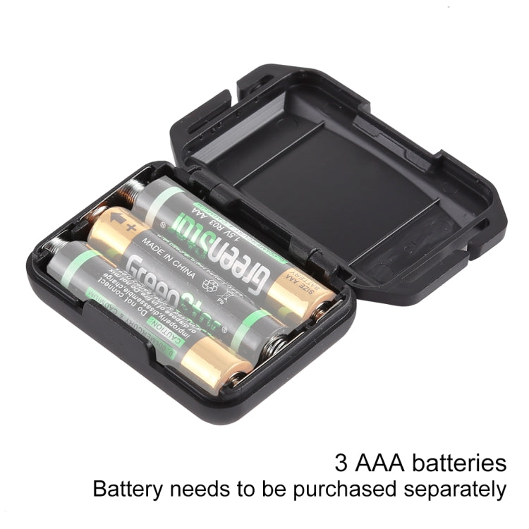 Open black battery compartment holding three AAA batteries