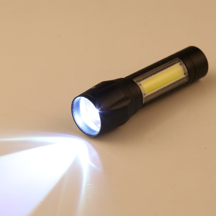 Dark flashlight with COB bulb lit, showing bright beam from the front