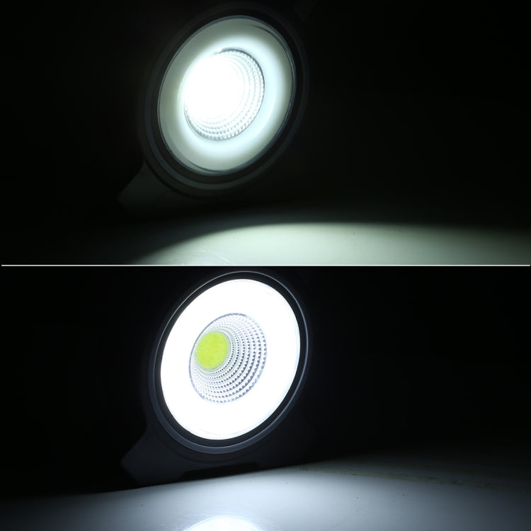 Black handheld camping lamp lit with bright circular COB LED