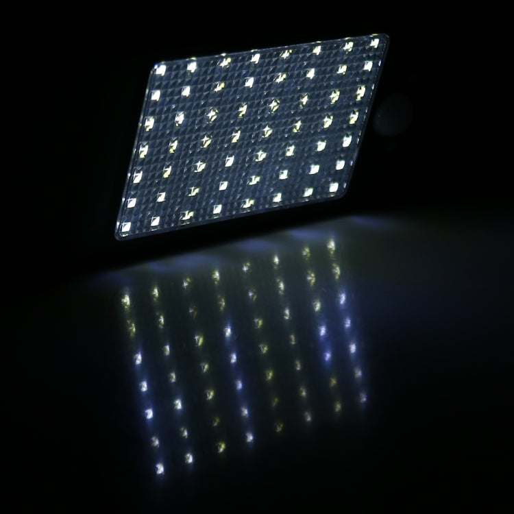 Solar wall light LED panel glowing bright white, black motion-sensor housing