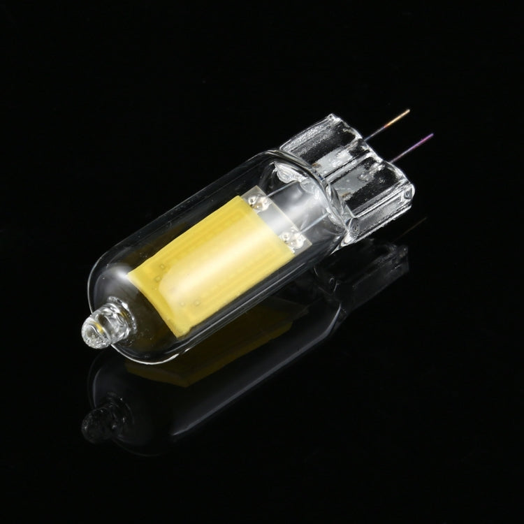 Glass LED bulb with rounded clear capsule, two pins, and a yellow LED element