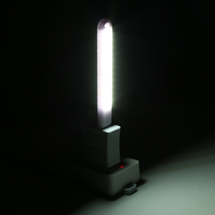 Black base USB LED book light emitting a vertical white light strip