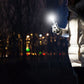 Handheld white USB LED light emitting a bright beam at night