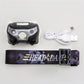 LED headlamp kit with USB cable and purple patterned adjustable head strap