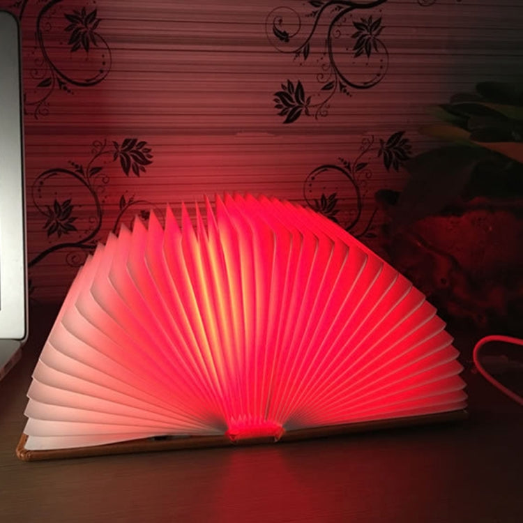 Red glowing foldable fan night light with ribbed panels and central light