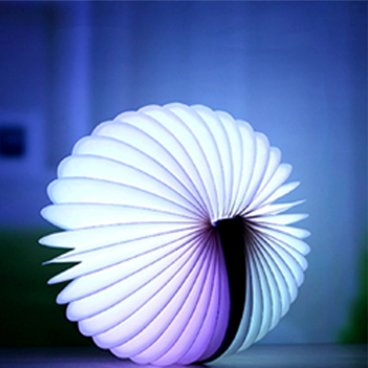 White-blue folding semicircle night light, softly glowing