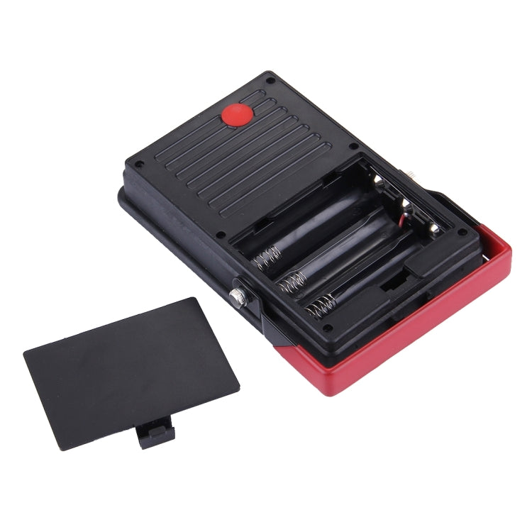 Black LED emergency light with open battery compartment and red base
