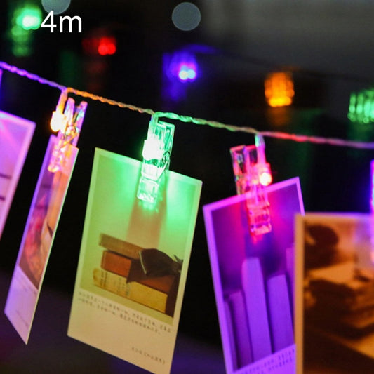 Colorful LED string lights with photo clips on hanging wire, multicolor bulbs glowing