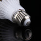 E27 screw base on white LED motion sensor bulb with metal threads and contact button