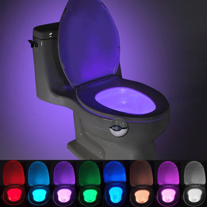 Grey toilet seat night light with purple LED glow on the lid