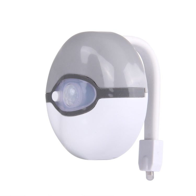 Grey and white toilet seat night light with built-in motion sensor lens