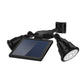 Solar LED spotlight with dual heads, tilted solar panel, and wall mount bracket