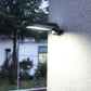 Black outdoor solar wall lamp with motion sensor emitting bright light