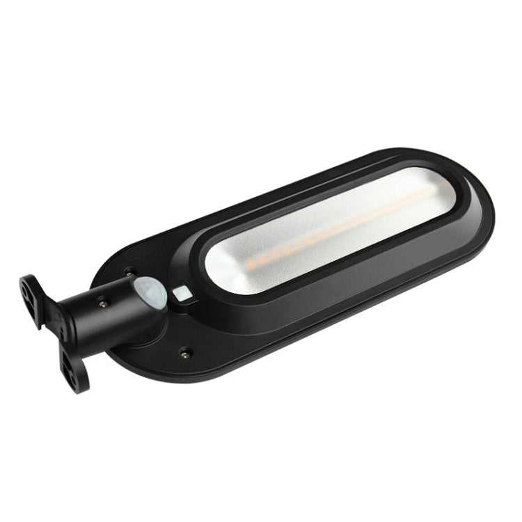 Black solar street lamp with glowing oval LED diffuser light head