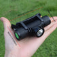 Adjustable LED headlamp held in hand, black light housing with textured grips