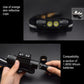 Black headlamp with orange reflective strip cups and dual front LED bulbs