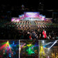 Outdoor concert stage with overhead lighting and large crowd in front