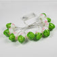 Easter egg LED string lights with green and pink painted bulbs on silver wire