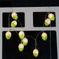 LED Easter egg string lights hanging from display card, green eggs with pink flowers