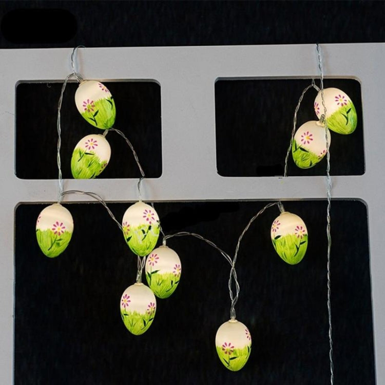 LED Easter egg string lights hanging from display card, green eggs with pink flowers