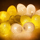 Glowing yellow and warm white egg light string with cotton-thread globe bulbs
