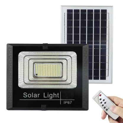 Solar LED flood light with solar panel, black housing, and handheld remote control