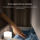 Mini USB night light on a bedside surface, emitting a soft white glow.