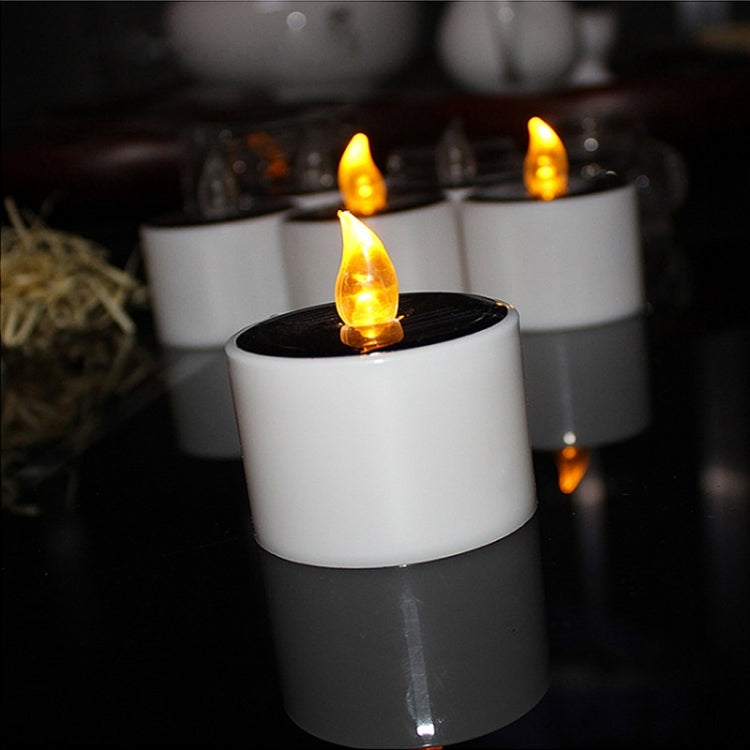 Front view of lit white LED candle night light with glowing flame effect topper
