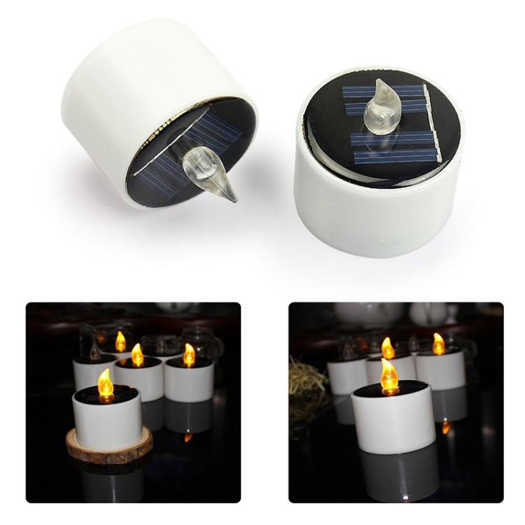 Two white LED candle night lights with dark solar panel tops and clear flame caps