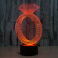 Diamond-ring LED desk lamp glowing red with diamond top and oval ring